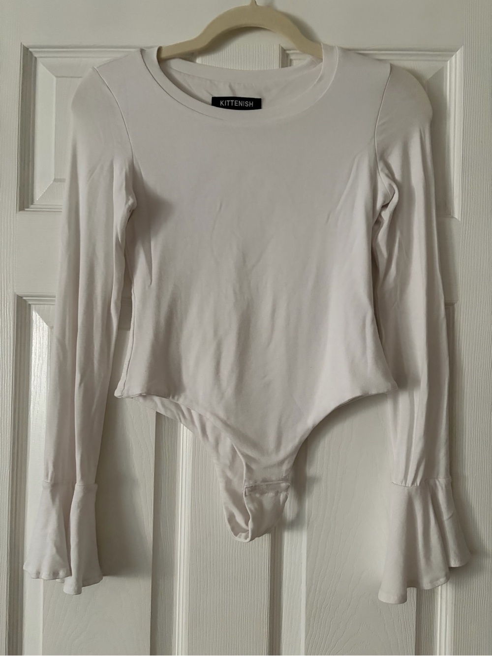 Kittenish Cream Long-Sleeve Ruffle Cuff Bodysuit